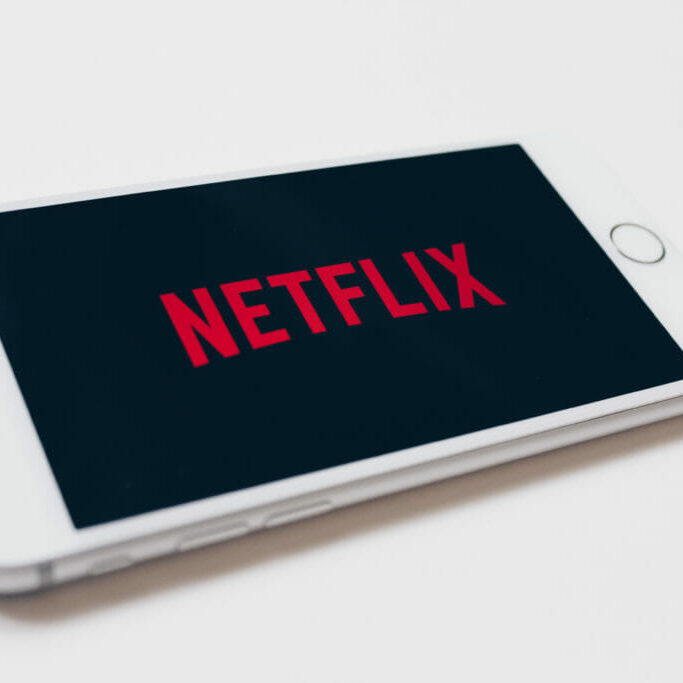 27001368237_12034e40a6_o In this image: A phone with the Netflix logo on it.