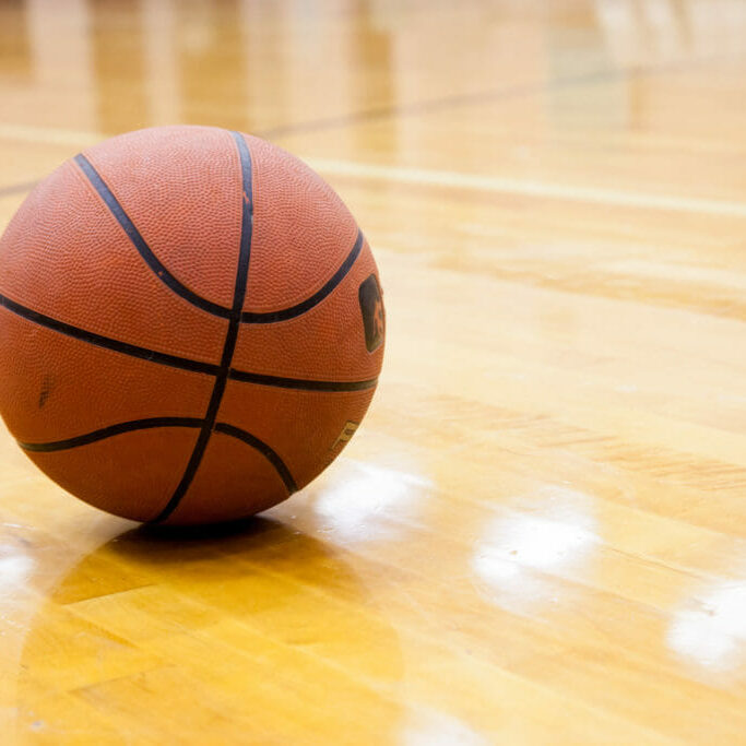 In this image: A basketball in gymnasium.