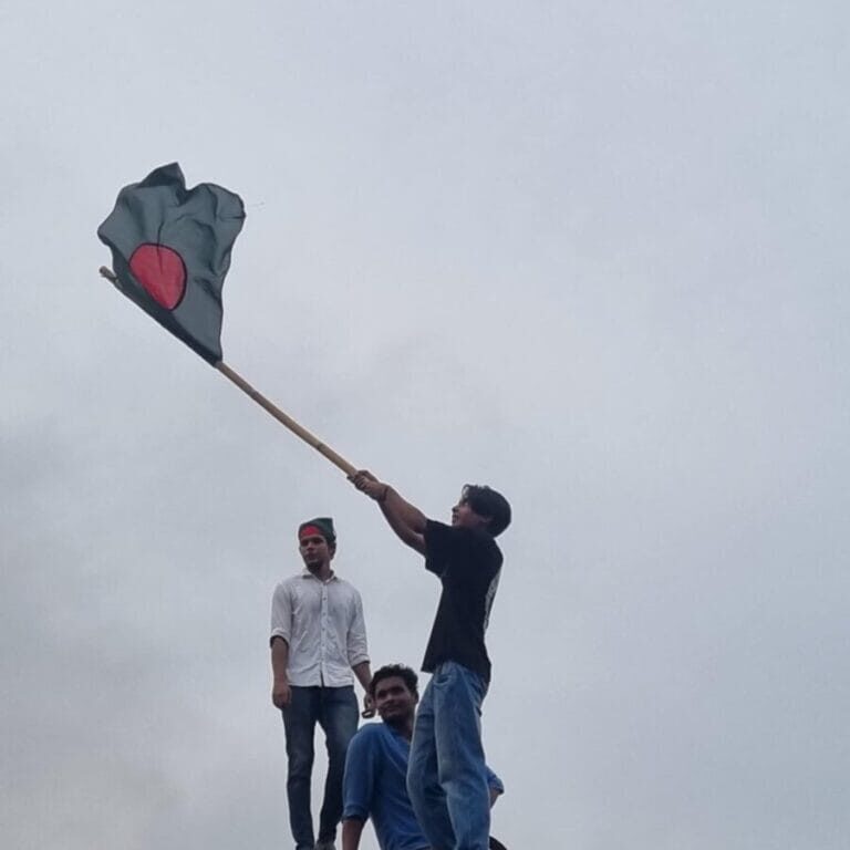 Affan Tariq Farhan waves the Bangladeshi flag on August 5th, 2024, the day the former prime minister resigned. Photo credit: Farhana Akhter