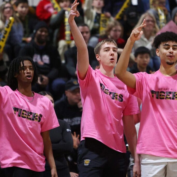 Dalhousie University men’s basketball players celebrate from the bench.