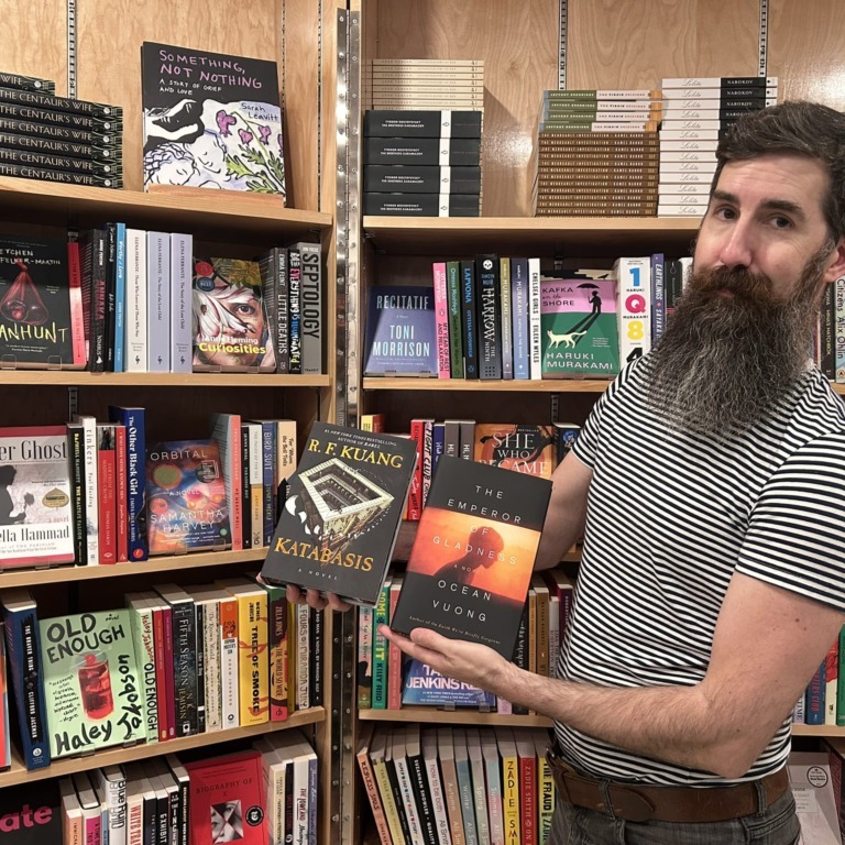 King’s Co-op Bookstore manager Paul MacKay poses with summer bestsellers Katabasis and The Emperor of Gladness inside the bookstore at the University of King’s College in Halifax, N.S., on Thursday, Sept. 4, 2025. (Jenna Olsen/The Dalhousie Gazette)