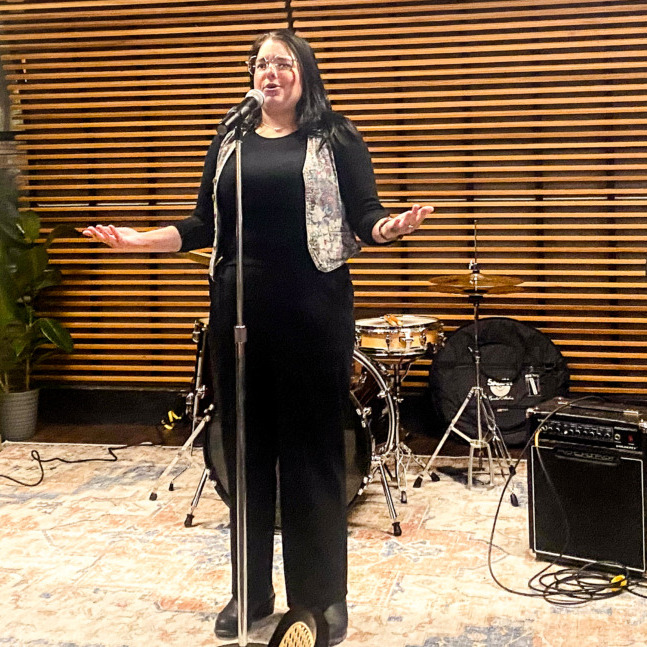 Performers take the stage during a talent show hosted by CKDU at the Abstract Cafe, in Halifax, Nova Scotia, on Thursday, Nov. 20, 2025. (Mariana Luz/The Dalhousie Gazette)