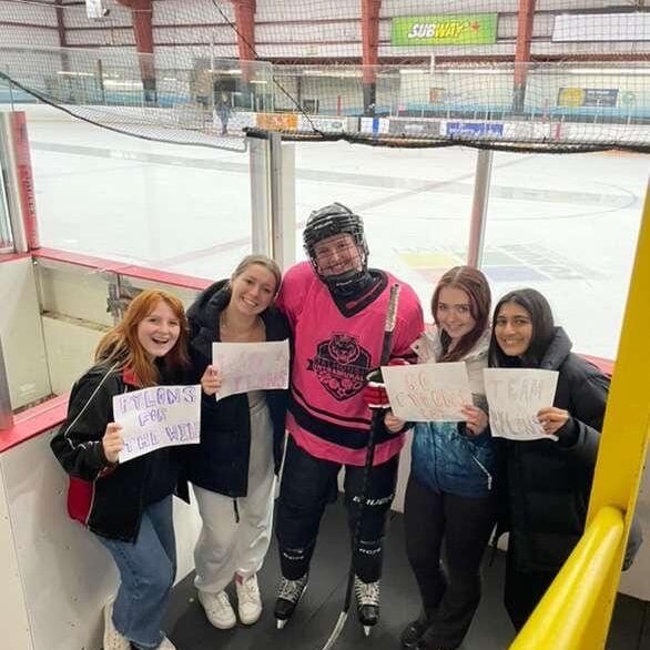 A member of the Pylons is embraced by her friends during a Dalhousie University intramural game at the Halifax Forum. 