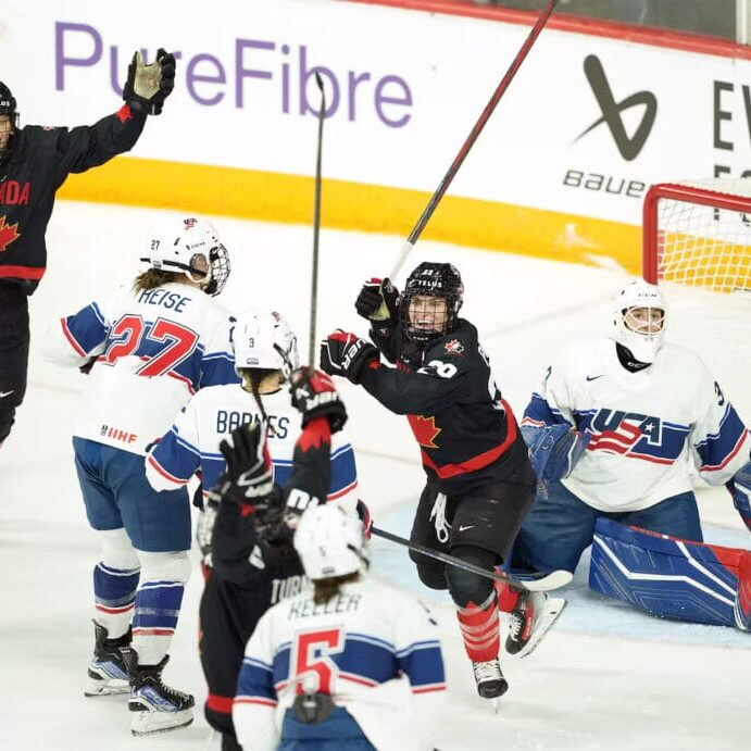 Canada women’s national team players Marie-Philip Poulin (right) and Laura Stacey (left) celebrate Blayre Turnbull’s tying goal on Feb.6, 2025 at the Scotiabank Centre in Halifax, NS. Photo by Darren Calabrese/The Canadian Press.