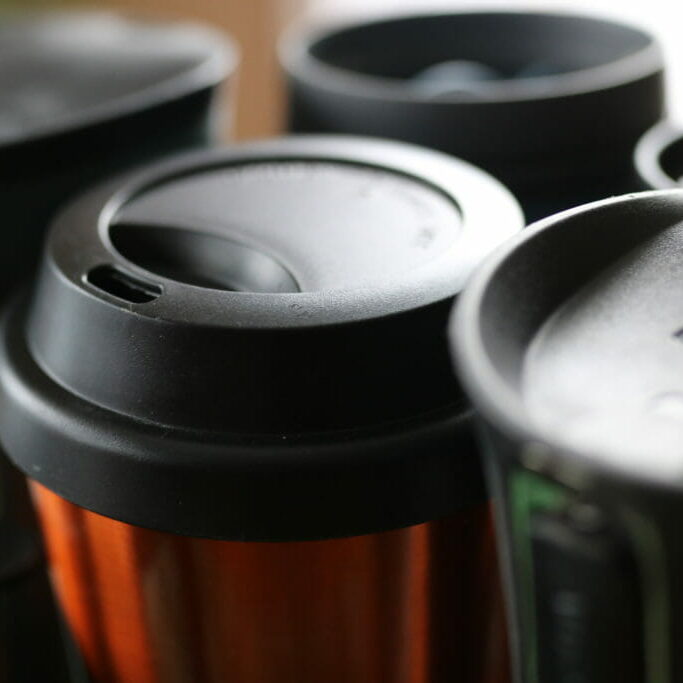 In this image: A handful of reusable mugs.