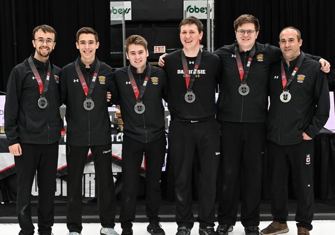 The men’s team stands with their silver medals following their loss to the University of Regina. Image credit: Rob Blanchard with Curling Canada