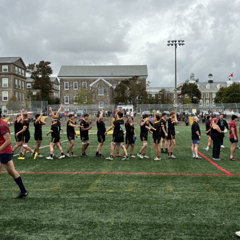 The Dalhousie men’s rugby club celebrates after a victory against Acadia at Wickwire Field. Photo by Wyatt Carling. 