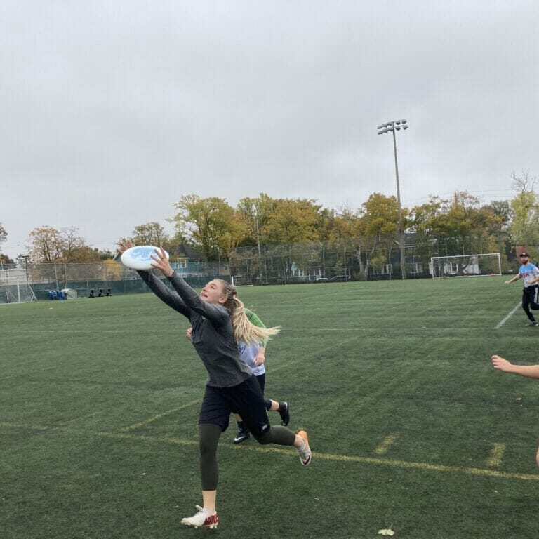 DKUT player Leah Fulton leaps for a catch, while also barely staying in bounds. Her team would score moments later. (Photo by Luke Dyment)