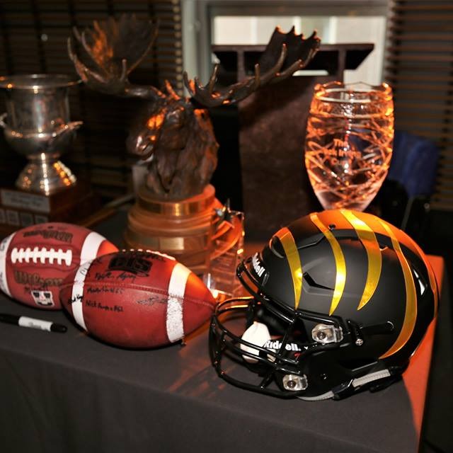 A football helmet and two footballs sit on a table in Halifax, Nova Scotia. (Mark Kays/Dalhousie University Website) August 27, 2019