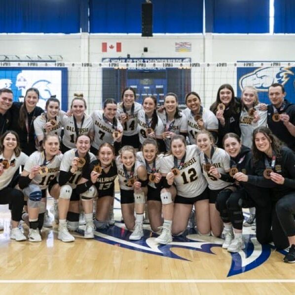 Last year's women's volleyball team posing with their bronze medals at the U Sports volleyball championship. Image credit: U Sports Volleyball on X