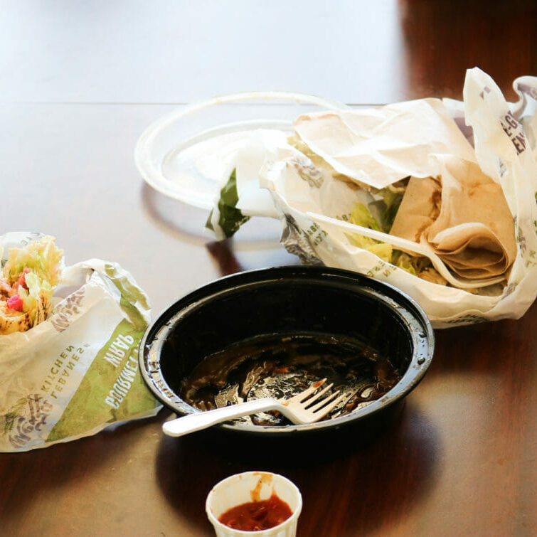 In this image: leftover Mezza container and wrapping on a table in the Dal Student Union Building.