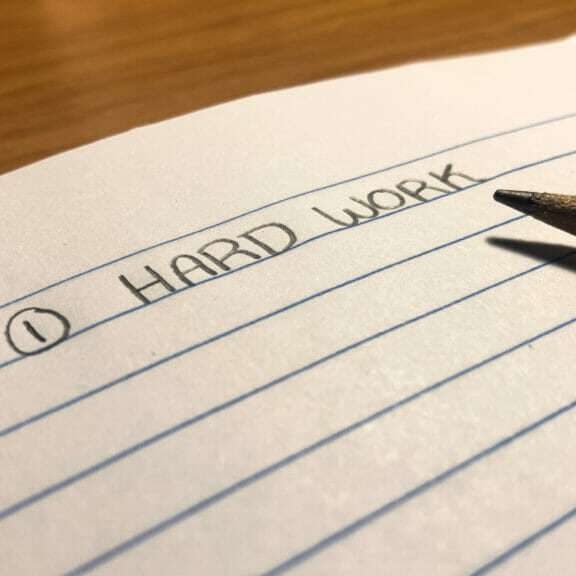 DoesHardWorkPayOff In this image: A notebook with "Hard Work" written on it.