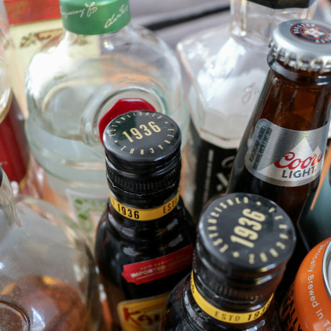 In this image: Different bottles of alcohol in a group.