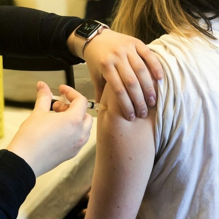 Flu shots_Karla Renic A person giving a flu shot to a patient.
