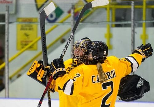 Dalhousie women’s hockey players Grace Beer [left] and Katie Cameron [right] celebrate after a win at the Halifax Forum in Nova Scotia. 