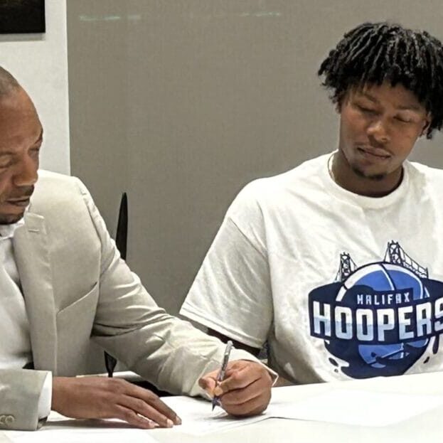 HFX Hoopers (1) Owner Geoff Clyke (left) signs C.J. Bennett as the first player for the Halifax Hoopers. Photo by Jack Sponagle/The Signal.