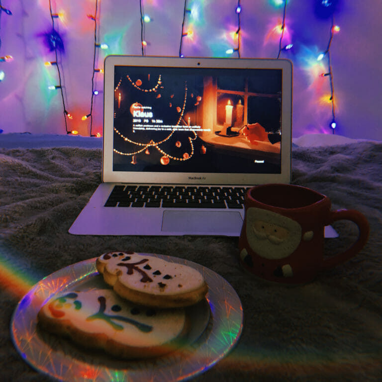 In this image: A MacBook Air with Klaus playing and cookies in the foreground.