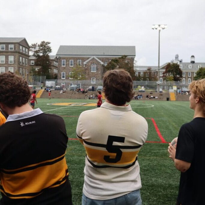 A group of Dalhousie University men’s rugby alumni watch a game between Dalhousie and Acadia University on Oct. 5, 2024 at Wickwire Field in Halifax, NS. Dalhousie won the match 57-5.