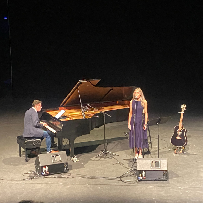 Ally Cribb performs on stage at the Sir James Dunn Theatre on Friday, April 10, 2026. (Mariana Luz/The Dalhousie Gazette)