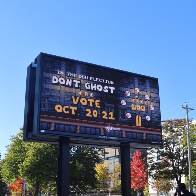 A sign advertising the Dalhousie Student Unions by-elections outside the Student Union building. (Dylan Follett/The Dalhousie Gazette)
