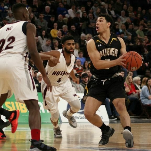 Jordan Brathwaite looks to pass the ball to Mike Shoveller as he is guarded by Andre Ntivumbura and Nevell Provo. 