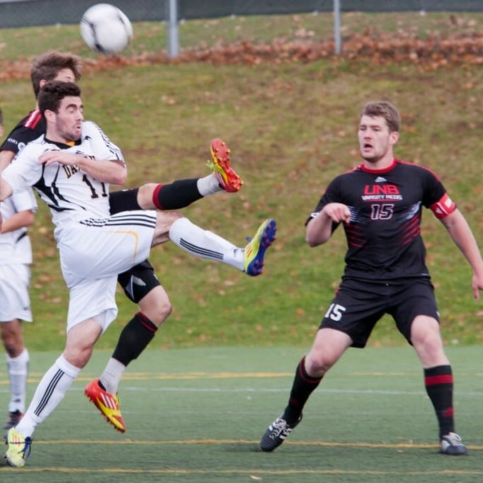 Tyler Lewars fights for possession in Dal's fourth consecutive semifinal loss. (Photo via UPEI Photography)
