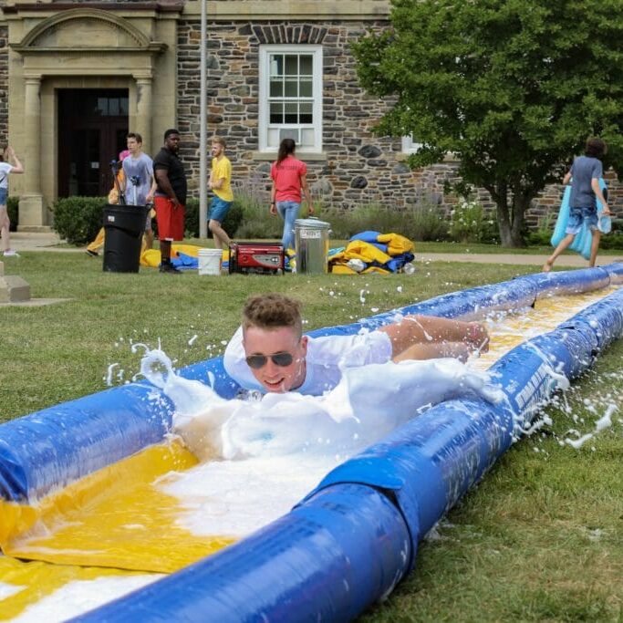 Sam Sedgwick was among the first to try this year's Slip and Slide track at the Meteor Shower event in the quad. 