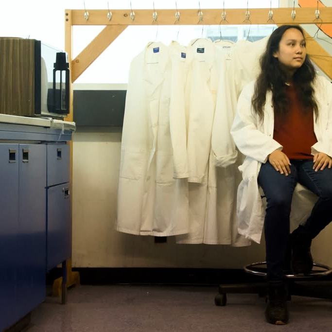 Kelly Lau is surrounded by items that reflect her research and personal interests in a genetics lab at Dalhousie University on Sept. 28, 2026 in Halifax N.S. (Ferris Kerr/The Dalhousie Gazette)