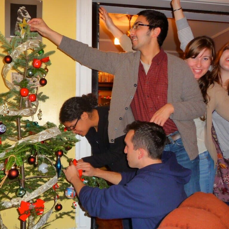 Decorating our Christmas tree last year with some broken ornaments we found in a box on a curb.