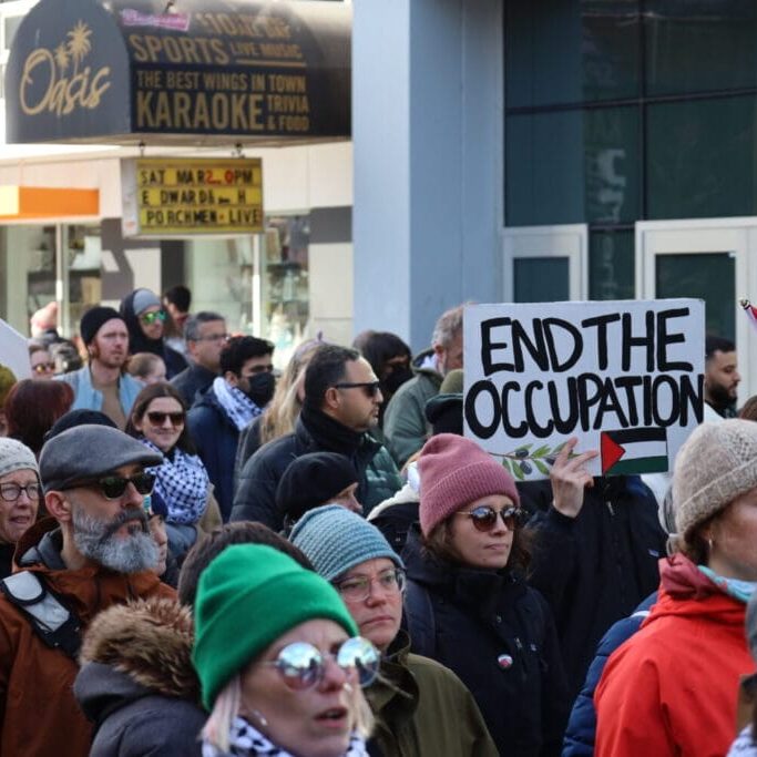 Protestors march down Spring Garden Road in Halifax, NS, on Saturday, March 2, 2024. Protestors marched from Victoria Park to Peace and Friendship Park, calling for a ceasefire in the genocide against Palestinians in Gaza (Image by Jenna Olsen)