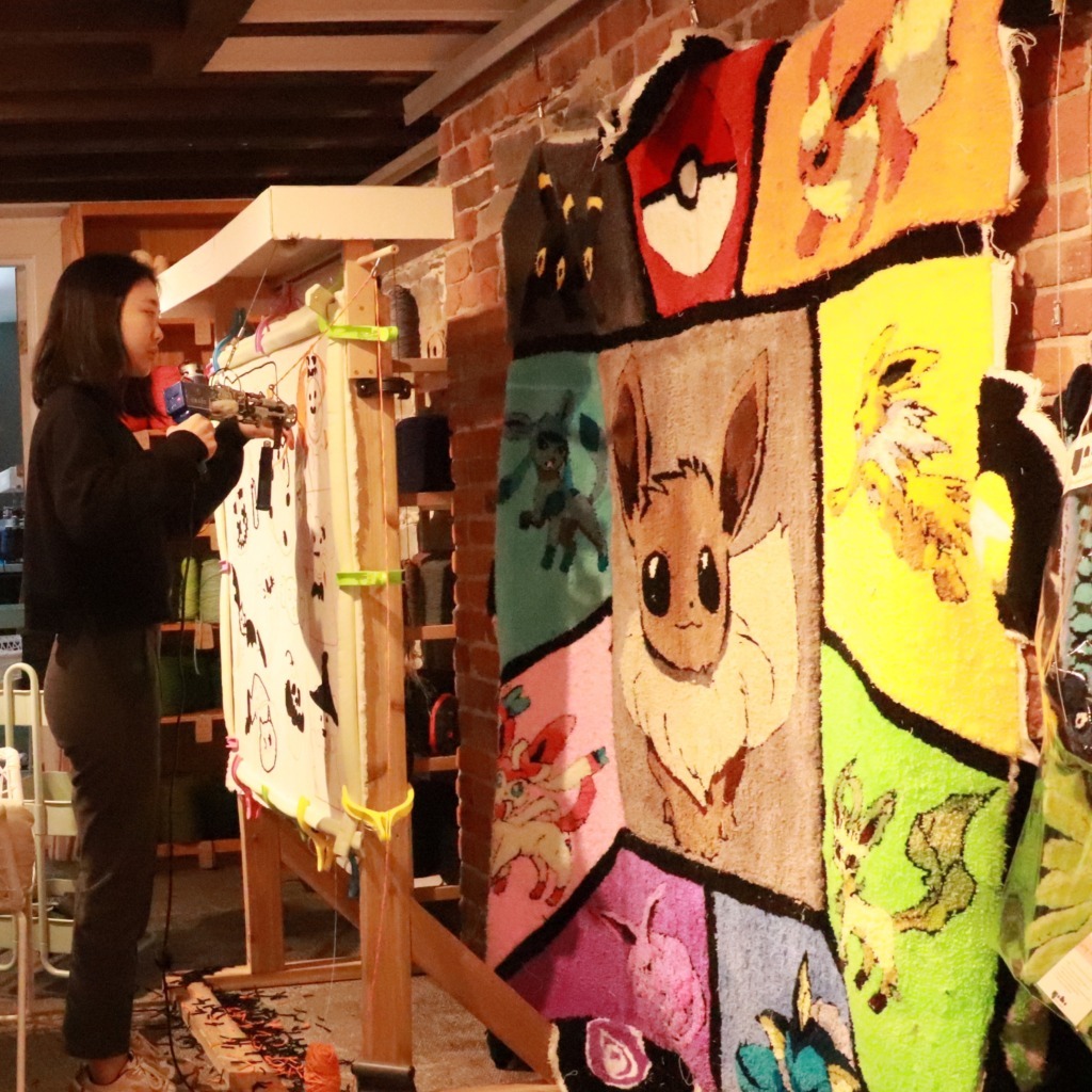 YOLO Craft owner Yang Wen works on a rug at their workspace in Halifax, Nova Scotia, on Monday, Mar. 2, 2026. (Image courtesy of Yang Wen)