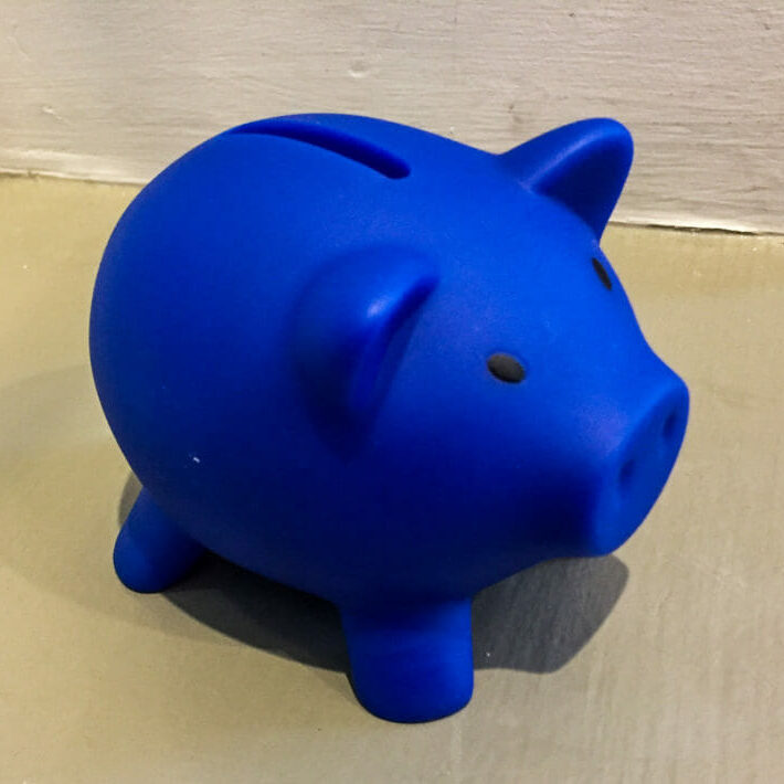 In this image: A blue piggybank.