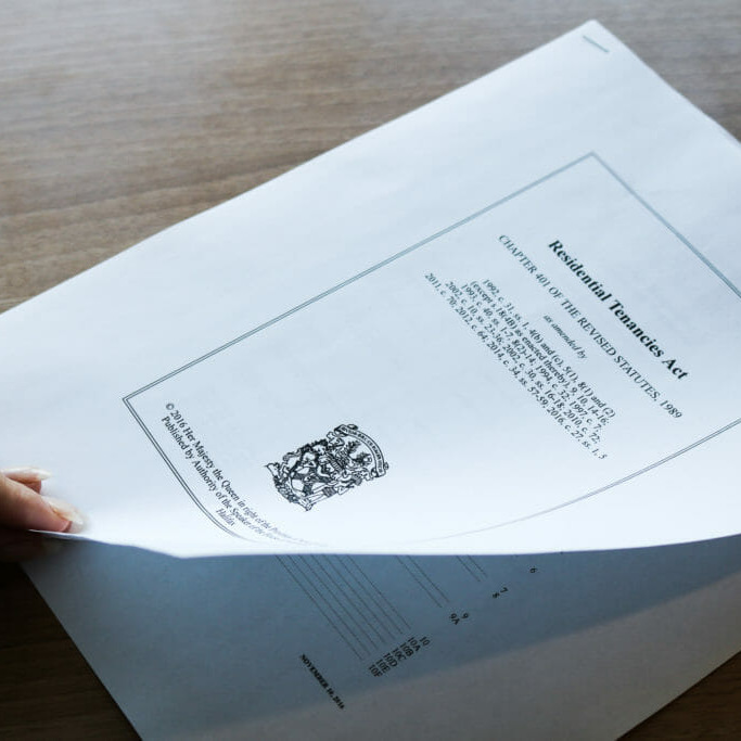 In this image: Someone about to turn the page on the Nova Scotia Residential Tenancies Act