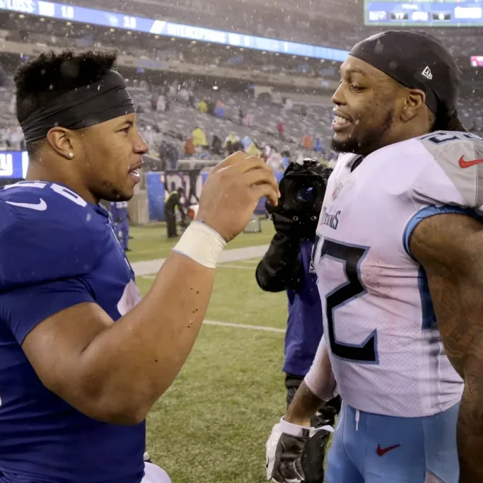 NFL running backs Derrick Henry and Saquon Barkley converse during a game between the New York Giants and Tennessee Titans. Photo by Seth Wenig AP Photo.
