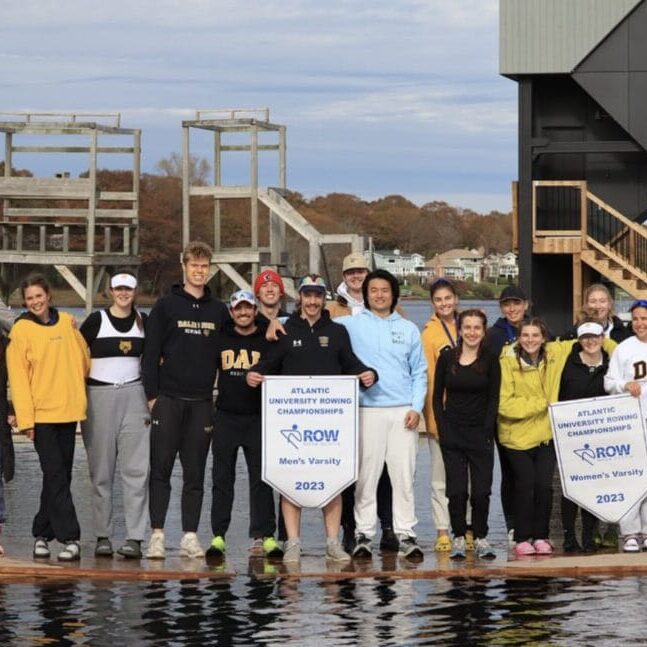 The Dal Rowing team posing with their Men's and Women's Atlantic University Rowing banners. Image credit: Dal Rowing on Instagram