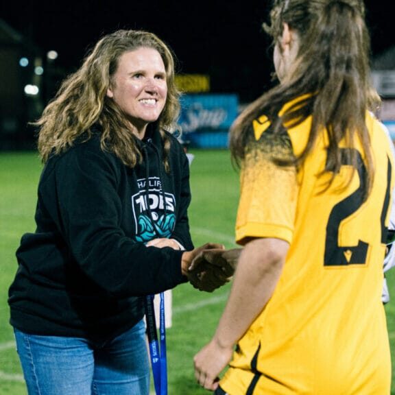 Halifax Tides CEO Courtney Sherlock shakes the hand of a young women’s soccer player. 
