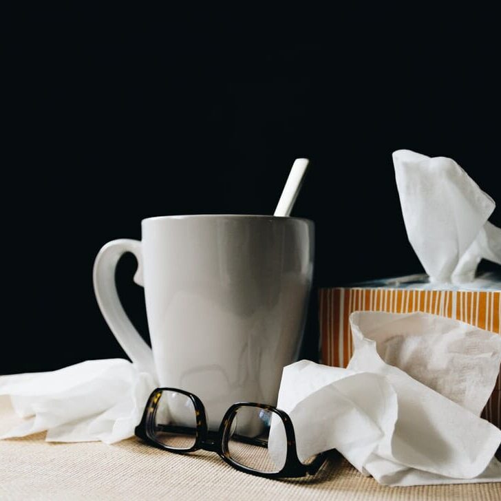 In this image: Tissue, glasses and a white mug.