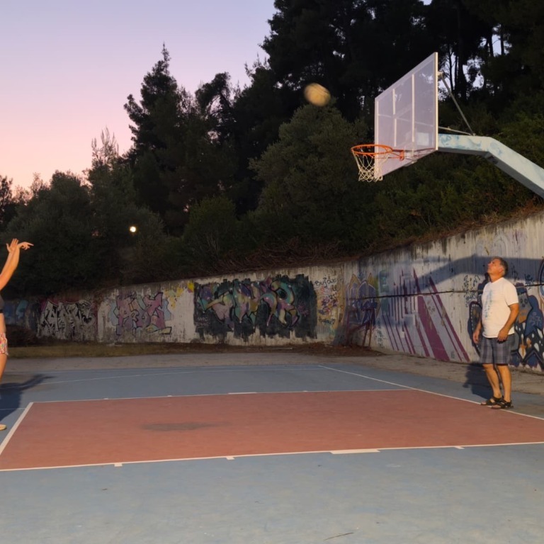 Simona Matic takes shots on a basketball hoop in Serbia with her father. (Image courtesy of Simona Matic)