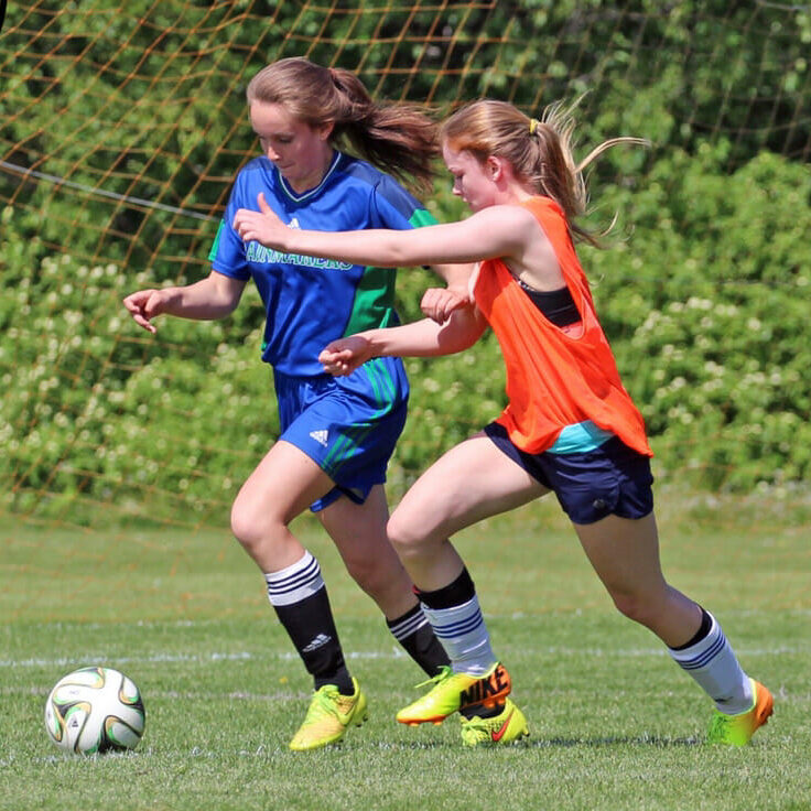 In this image: Alexi Armstrong playing a game with her high school soccer team.