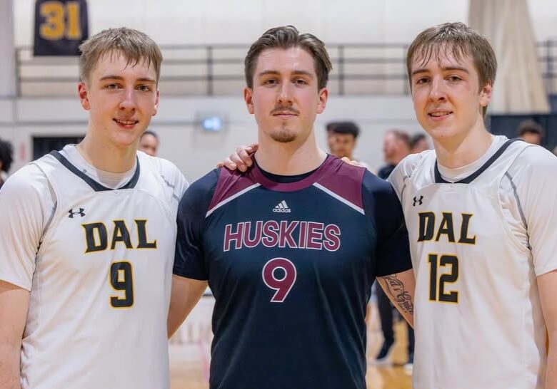 Caleb [left], Micah [centre], and Riley Stewart pose for a photo after Saint Mary’s University played Dalhousie University’s men’s basketball team at the Dalplex in Halifax, NS. 
