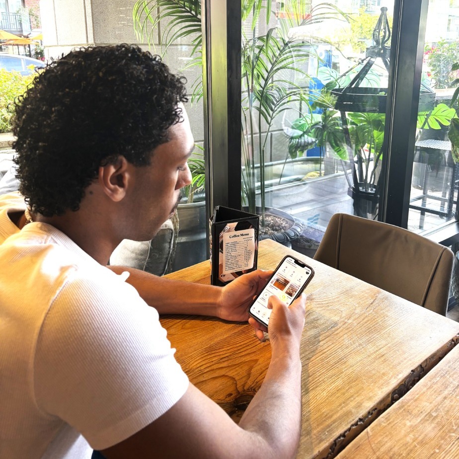 Faris Mohamed, CEO and founder of SubSwap, uses the app he co-founded at the Daily Grind in Halifax, Nova Scotia, on Wednesday, Aug. 27, 2026. (Charlotte Wood/The Dalhousie Gazette)