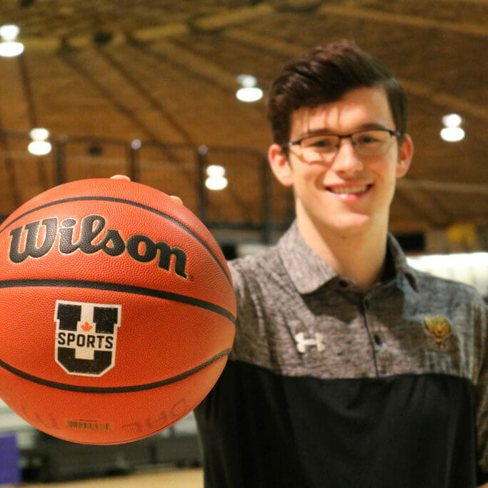 In this image: Sven Stammberger holds a basketball up to the camera.