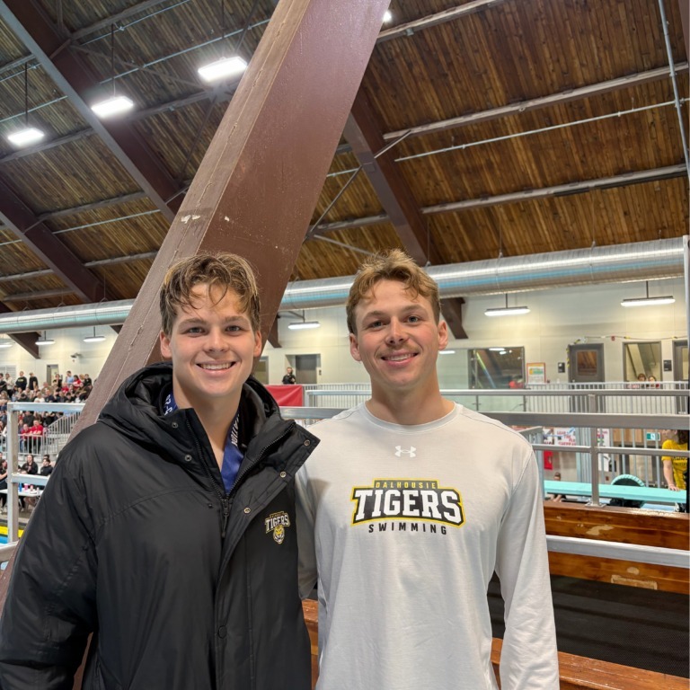 (L to R) Declan and Quinn Nolan pose together at an AUS invitational swimming competition. (Image courtesy of Quinn Nolan)