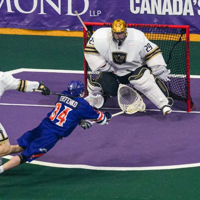 Halifax Thunderbird Ryan Terefenko dives to take a shot on the goalie while being pressed by a defender. Photo by Jake Piper.