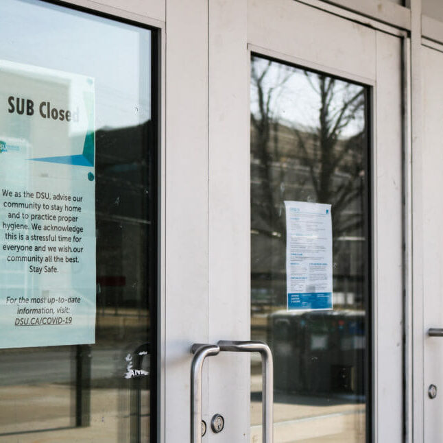 TheLostYear_ChrisStoodley In this image: Signs posted on Dalhousie University's Student Union Building saying it's closed due to COVID-19.