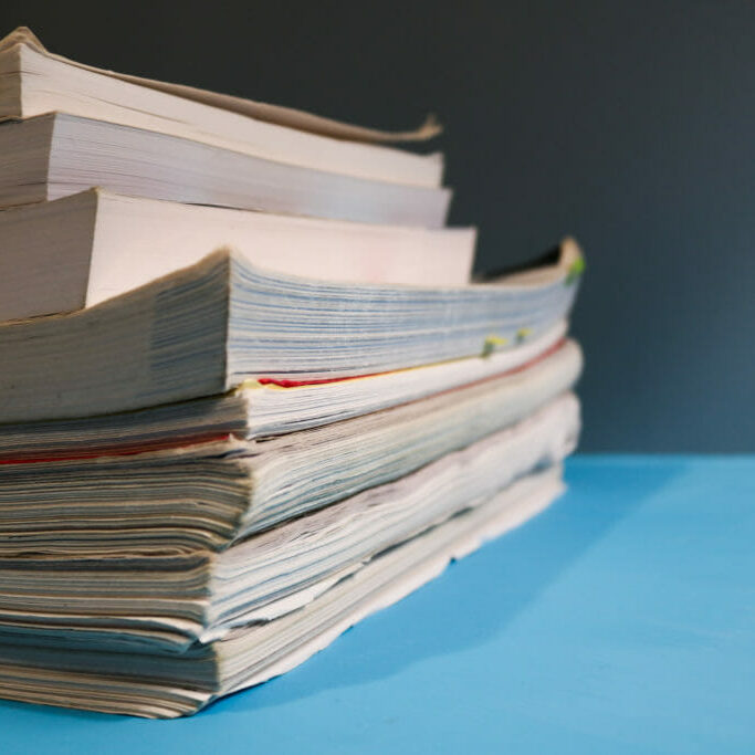 In this image: A stack of textbooks.