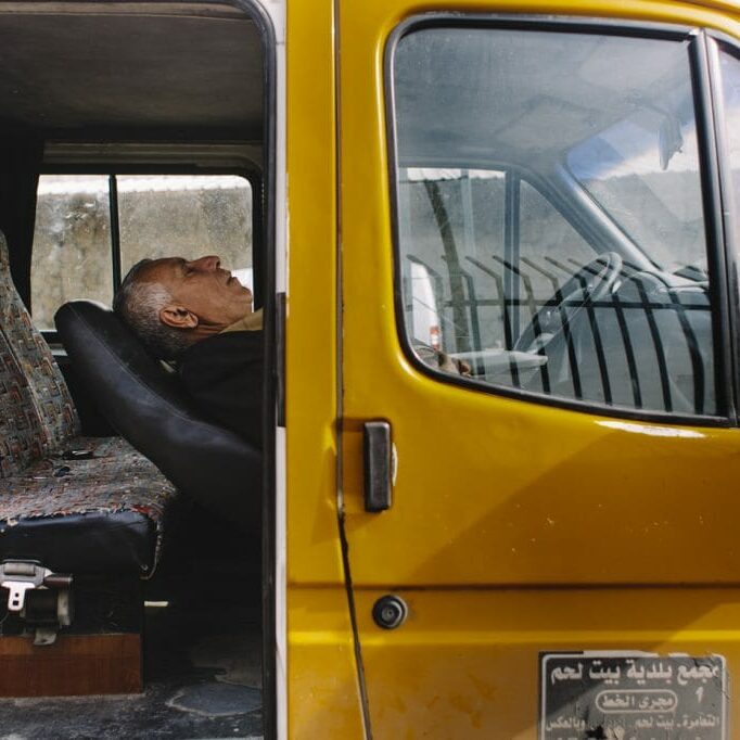 Palestinian man resting in his van; Bethlehem, Palestine.