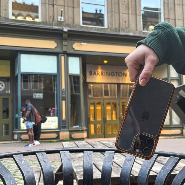 An Apple iPhone gets thrown in the trash. (Enzo Stimpson/The Dalhousie Gazette)
