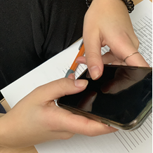 In this image: A person holds their cellphone as if they're typing.