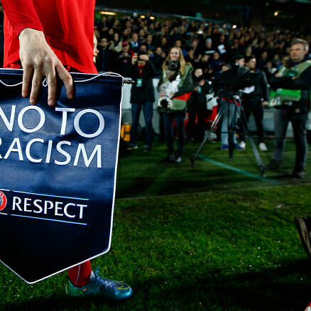 HERNING, DENMARK - OCTOBER 22:  Morten Rasmussen of FC Midtjylland walks out onto the pitch with a No to Racism pennant during the UEFA Europa League Group D match between FC Midtjylland and SSC Napoli at the Arena Herning on October 22, 2015 in Herning, Denmark.  (Photo by Christopher Lee - UEFA/UEFA via Getty Images)